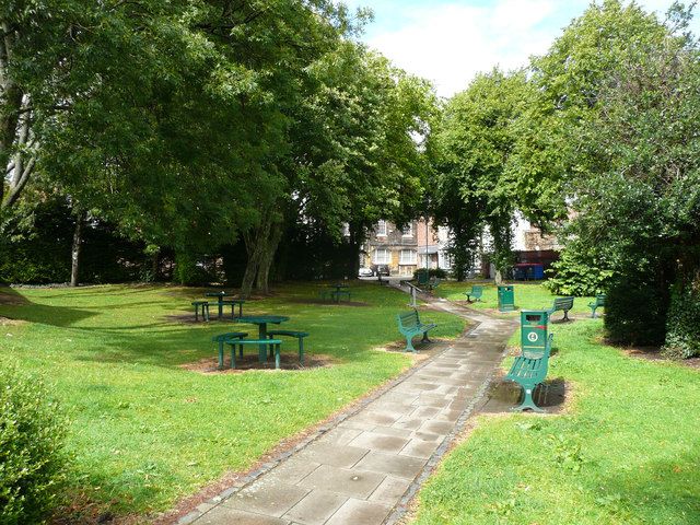 Small town-centre park in Guisborough with paths, benches and mature trees